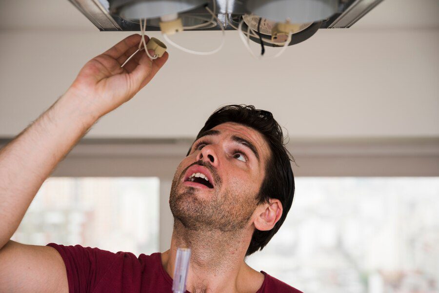 close-up-male-electrician-installing-holder-ceiling-light_23-2148087646 Close-up of male electrician installing holder of ceiling light<br />